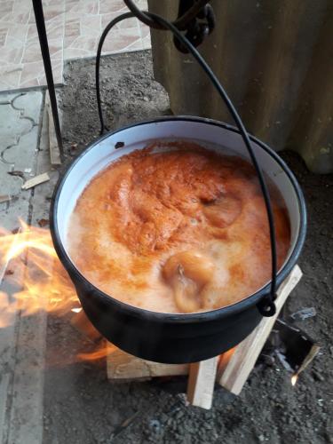a pot of food cooking on top of a fire at VILANATALIJA PANSION, APATIN in Apatin