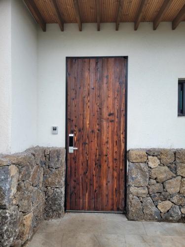 a wooden door on the side of a building at Joohane Jejudo House in Jeju