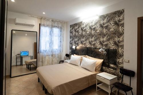 - une chambre avec un grand lit et une fresque murale dans l'établissement Ospitalità e Fotografia, à Agliana