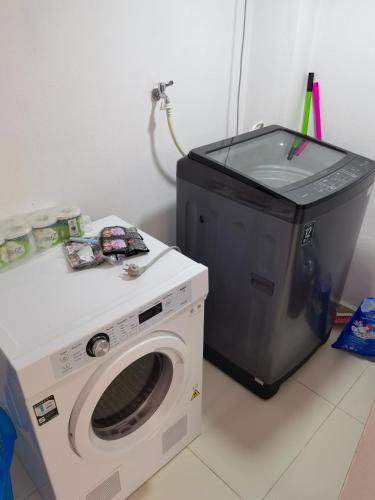 a washing machine and a tv in a room at ChanthaSouk Vang Vieng Entire Villa in Vang Vieng