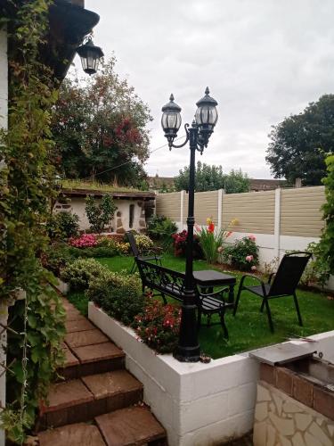 GildingwellsにあるQTのランプポストとベンチと花の庭園