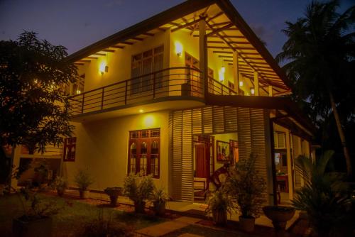 a large house with a balcony on top of it at Villa A.SMS in Induruwa