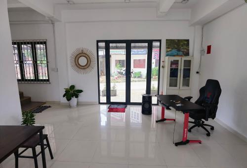 a white room with a desk and chairs in it at ChanthaSouk Vang Vieng Entire Villa in Vang Vieng