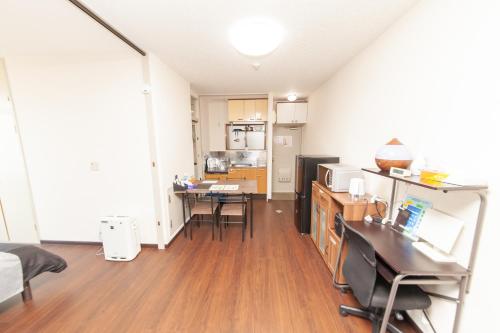 a living room with a kitchen and a dining room at Big Stone Tsukuda 45平米 2SDbed 2For3F in Aomori