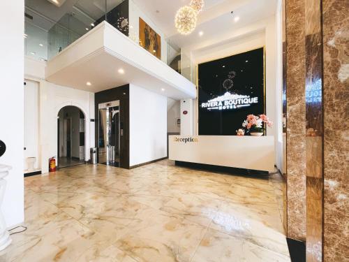 a lobby with a marble floor and a staircase at Rivera Boutique Hotel in Da Nang