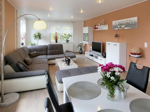 a living room with a couch and a table at Ferienwohnungen Haus Angela in Mühlhausen