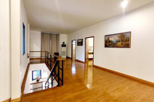 a living room with a staircase and a painting on the wall at Bann White Chalet Khaoyai in Mu Si
