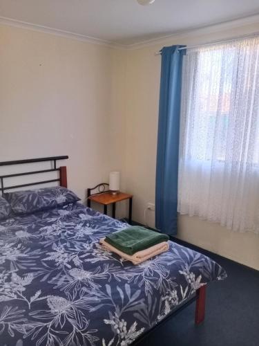 A bed or beds in a room at Weslan Accommodation