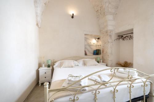 a white bedroom with a white bed in a room at Suite Cavour 30 in Ostuni