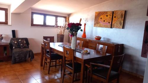 a dining room with a wooden table and chairs at Angel's House in Bianco