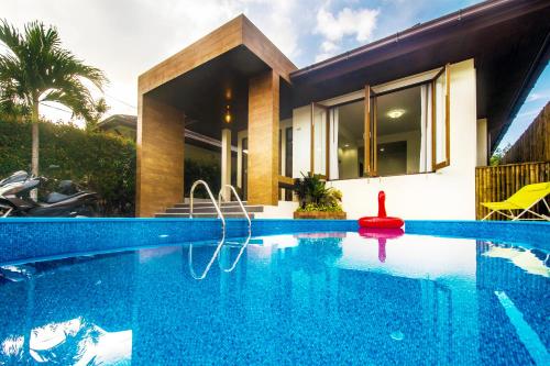 a swimming pool in front of a house at Villa SEAesta in Ao Nang Beach