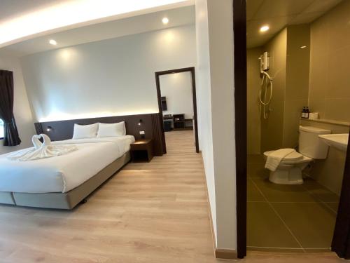Habitación de hotel con cama y baño en GEEN Hotel Chonburi en Chon Buri