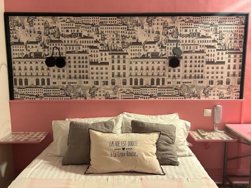 a bedroom with a wall with a picture of buildings at Hôtel de la Croix-Rousse in Lyon