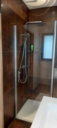 um chuveiro com uma porta de vidro na casa de banho em Villa face à la mer em Binic