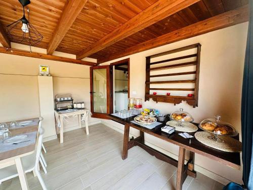 uma cozinha com uma mesa com alguma comida em Villa Blue Paradise - B&B con piscina non lontano da Cagliari em Cagliari