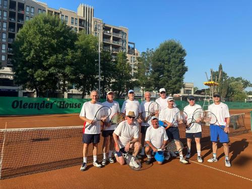 a tennis team posing for a picture on a tennis court at Oleander House and Tennis Club in Sunny Beach