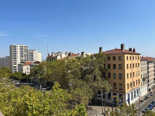 a view of a city with buildings and trees at Hôtel de la Croix-Rousse in Lyon