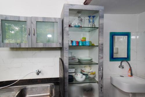 a kitchen with a sink and a sink at 6Tamarind in Gholvad