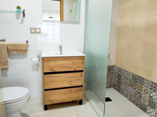 a bathroom with a sink and a toilet and a shower at Resort Home 10 in Sant Jordi