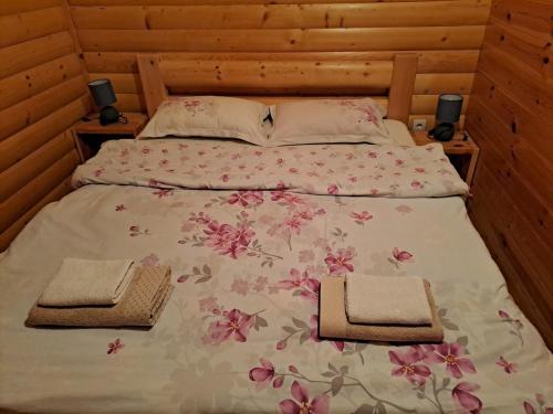 a bedroom with a bed with two towels on it at Planinska kuća in Žabljak