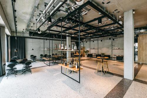 a large room with tables and chairs in it at aletto Hotel Potsdamer Platz in Berlin