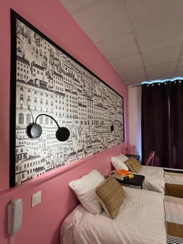 a room with two beds and a wall with a mural at Hôtel de la Croix-Rousse in Lyon