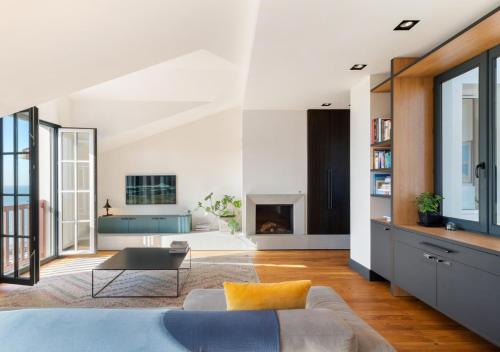 un salon avec un canapé et une cheminée dans l'établissement Appartement avec vue sur la côte des Basques By Ginto Hotels, à Biarritz
