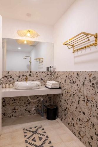 a bathroom with a sink and a mirror at Pisces Hotel Hue in Hue