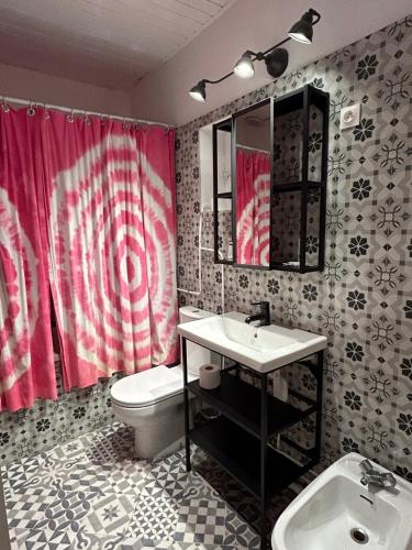 a bathroom with a sink and a toilet at Hôtel de la Croix-Rousse in Lyon