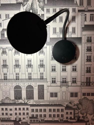 two black umbrellas hanging in front of a building at Hôtel de la Croix-Rousse in Lyon