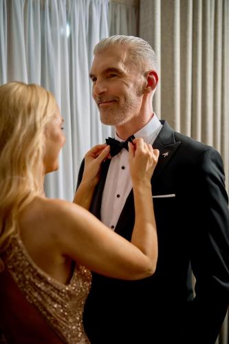 a woman helping a man tie his bow tie at Herbert Park Hotel and Park Residence in Dublin