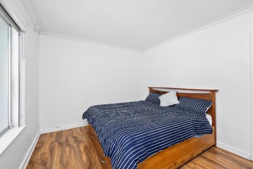 a bedroom with a bed with a striped blanket at 10/17 Richardson Street, South Perth in Perth