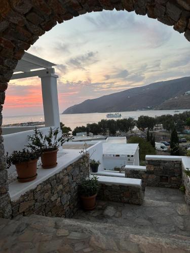 a view from an archway of a building with plants at Aelia Studios in Aegiali