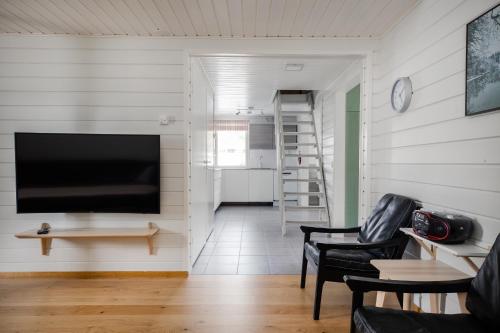 a living room with a flat screen tv on a wall at Levilehto Apartments in Levi