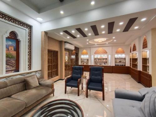 a living room with a couch and chairs at Durrat Nizwa Inn in Nizwa