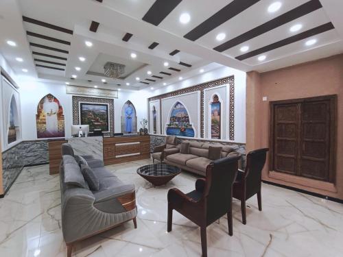 a large living room with couches and a fireplace at Durrat Nizwa Inn in Nizwa