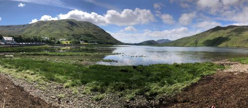 a body of water with mountains in the background at Bruíon Connemara in Cleggan