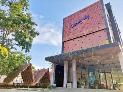 a building with a sign on the side of it at Catch Up Dambulla in Dambulla