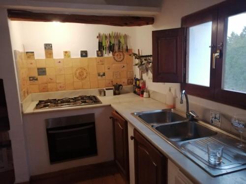 a kitchen with a sink and a stove at Els Castells in Illes Balears