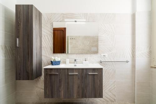 a bathroom with a sink and a mirror at Casa Rachele in Dorgali