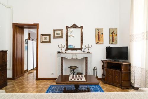 a living room with a fireplace and a tv at Casa Rachele in Dorgali