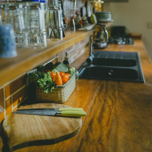 a basket of vegetables sitting on a counter in a kitchen at The Wooden Gate in Xuân Sơn