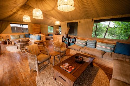 a living room with a couch and a table at Olkeri Camp in Olmotoni