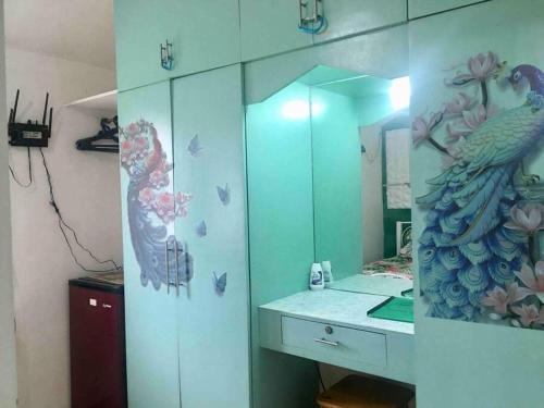 a bathroom with a peacock painted on the wall at Montalban GuestHouse 2 AC BR 4pax 200mbps WiFi FREE Netflix Shower Heater Parking in Rodriguez