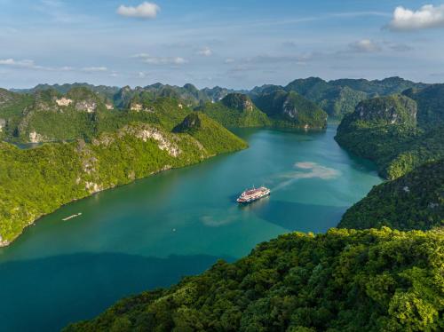 an island in the middle of a lake with a boat at Aqua Of The Seas Cruise Halong in Ha Long