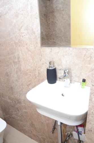 a bathroom with a white sink and a mirror at CRYTSAL RESIDENCY in Rānchī