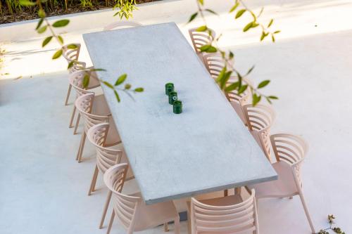 a table with two green bottles on top of it at Casa dos Pinheiros 109 - Private Villa with pool & heated SPA in Porto