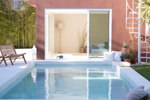 a swimming pool in the backyard of a house at Casa dos Pinheiros 109 - Private Villa with pool & heated SPA in Porto