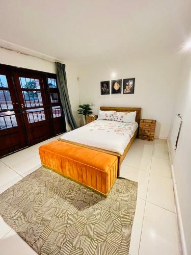 a bedroom with a large bed in a room at Soft petal in Pretoria