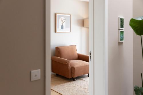 a living room with a chair in a room at Casa dos Pinheiros 109 - Private Villa with pool & heated SPA in Porto